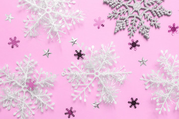 Christmas flat lay of multicolored snowflakes against blue background. Winter concept. New Year's holiday pattern