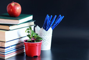 A stack of textbooks and books on the table. The concept of knowledge.