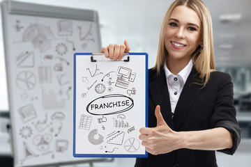 Business, technology, internet and network concept. Young businessman shows a key phrase: Franchise