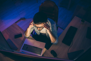 Hign angle above view photo of it skilled specialist guy sitting chair looking many monitors analyzing server debugging designing back-end security night office indoors