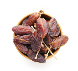 Bowl with dried dates on white background
