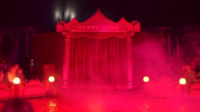Children's circus scene in red light