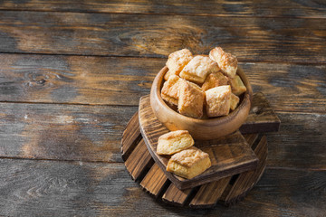 Cottage cheese cookies in a wooden bowl on a wooden table. Rustic style