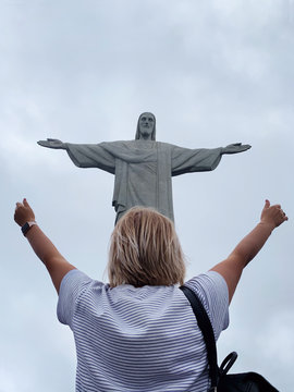 Rio De Janeiro, Brazil - 6 October 2019 Woman With Her Hands Up Near The Christ The Redeemer Statue