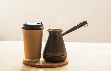 Hot turkish coffee pot on wooden table.