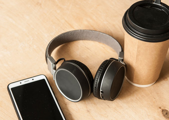 Smartphone, headphones, and a cup of coffee