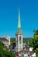 View of the historic center of Zurich at the bank of Limmat River, with beautiful house rooftops and  church of Predigerkirche, view form Lindenhof hill.