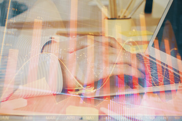 Multi exposure of stock market graph with man working on laptop on background. Concept of financial analysis.