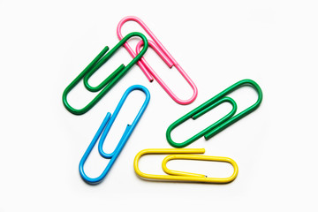 multicolored paper clips on a white background close-up