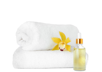 Obraz na płótnie Canvas Fresh towels, essential oil and exotic flower isolated on white