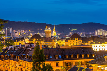 Obraz premium Night view of panorama of city view of old downtown of Zurich from campus of ETH , with beautiful house rooftops and lights.
