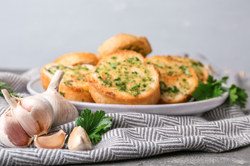 Slices of toasted bread with garlic and herbs on table