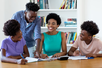 Laughing african american female tutor teaching students