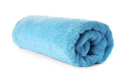 Rolled clean blue towel on white background