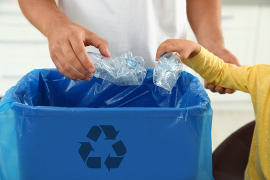Father and son sorting garbage in kitchen, closeup. Recycling concept - Powered by Adobe