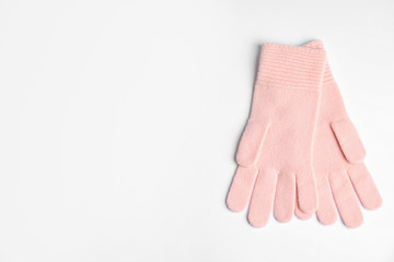 Stylish pink gloves on white background, top view with space for text. Autumn clothes