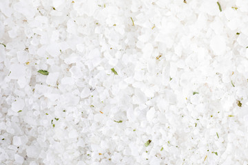 White sea salt as background, top view. Spa treatment