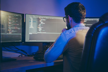 Rear back behind view portrait of nice focused skilled experienced guy thinking bug fixing...