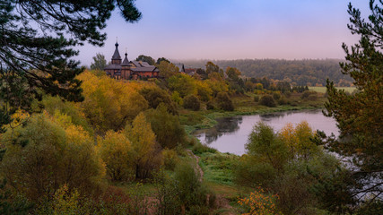 Obraz premium Sunrise on the misty river with the old church and blue sky