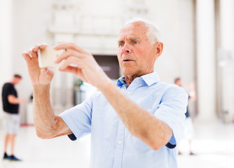 Man using smartphone in museum