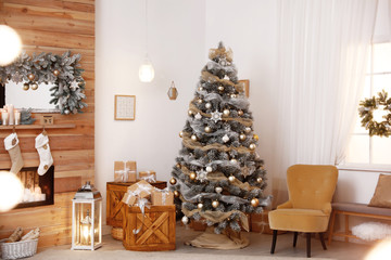 Festive interior with beautiful Christmas tree and gifts