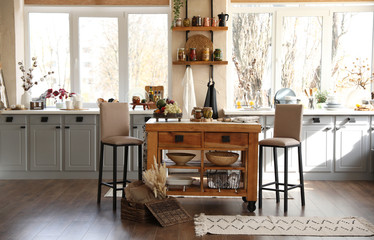 Stylish kitchen interior with wooden table and chairs
