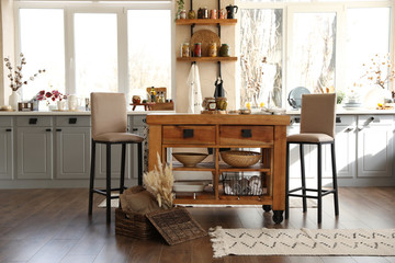 Stylish kitchen interior with wooden table and chairs