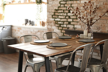 Stylish kitchen interior with dining table and chairs