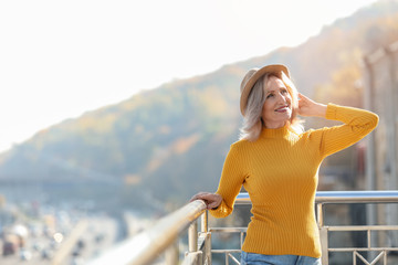 Fototapeta na wymiar Portrait of happy mature woman on balcony, outdoors