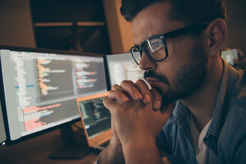 Profile photo of it specialist holding hands crossed fingers on chin looking monitors testing...
