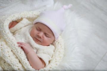 Baby newborn sleeping wrapped up in a blanket