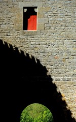 A castle wall with a red door  © Angela Harrod
