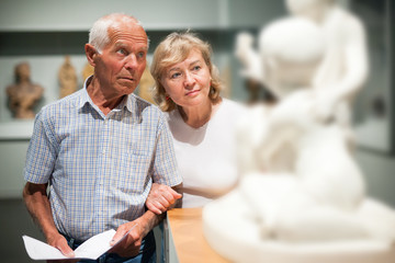 Male and female pensioners visiting museum