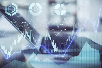 Forex graph hologram on table with computer background. Double exposure. Concept of financial markets.