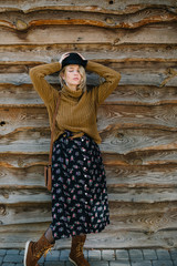 Boho style young woman in hat and orange sweater