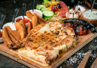 fried chicken tabaka in the furnace on wooden board