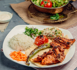 fried chicken with rice and vegetables