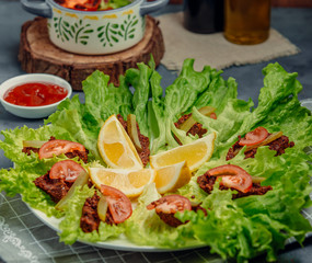 fried meat with tomatoes and vegetables