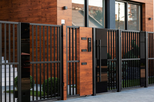 Intercom on safety gate in front of a house.