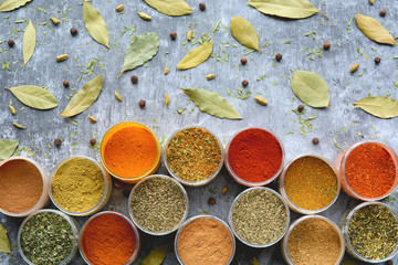 Variety of colorful herbs and spices in cups. Top view.