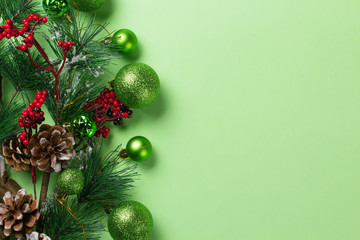 New Year background with christmas decorations on green.