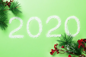 New Year background with christmas decorations on green.