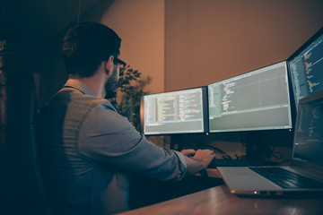 Profile side view of his he nice qualified skilled focused brunette guy specialist testing web site database fixing bugs debug tracking optimization blockchain in dark beige room workplace station