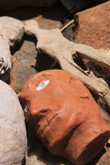 Close Up at a wooden head in the middle of other wooden objects representing human body parts deposited in a religious place in the interior of Piauí, northeast of Brazil, a poor and drought region