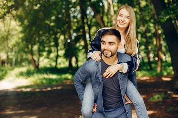 Couple in a forest. Beautiful blonde with her boyfriend