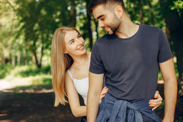 Fototapeta premium Couple in a forest. Beautiful blonde with her boyfriend