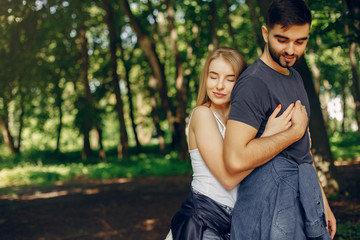 Couple in a forest. Beautiful blonde with her boyfriend