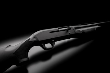Modern semi-automatic shotgun on black background. Modern weapons on a dark background. - obrazy, fototapety, plakaty