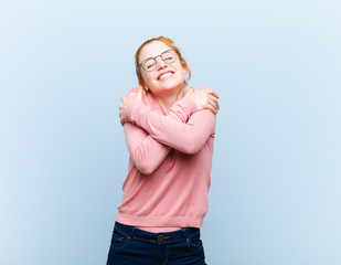 young red head pretty woman feeling in love, smiling, cuddling and hugging self, staying single,...