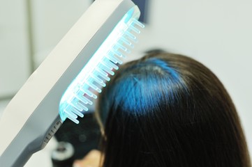 doctor dermatologist performs the procedure of ultraviolet comb to cure psoriasis. Phototherapy,...